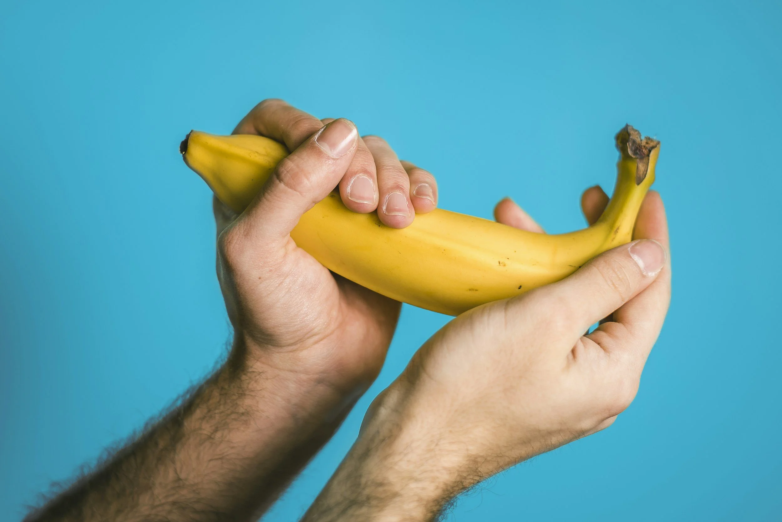 Erectile-health concept image of hands holding a banana