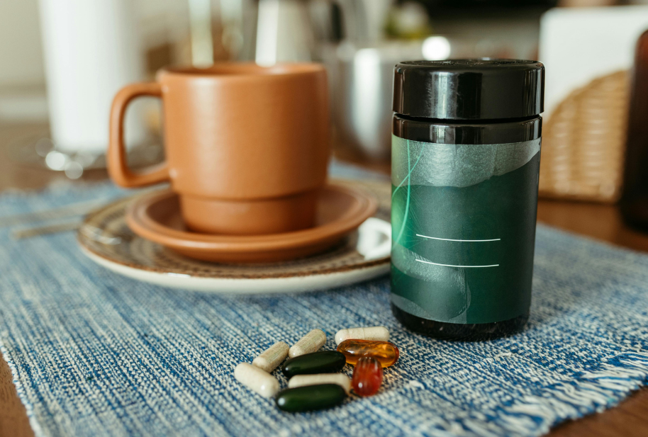 Daily vitamins and supplements beside a cup of tea