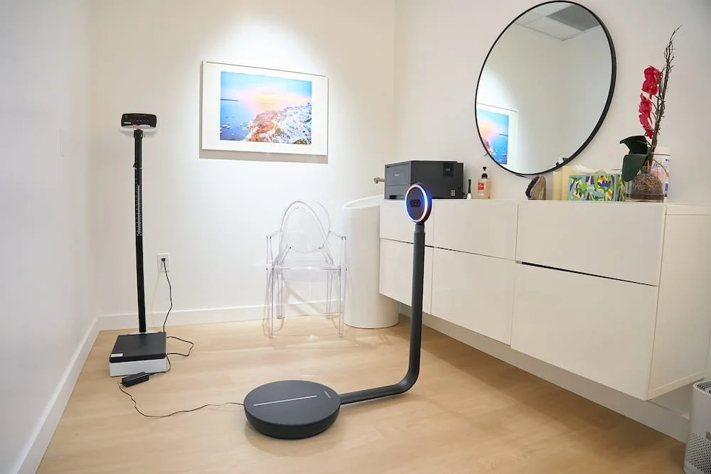 ShapeScale 3D body scanner in a room with a wall mirror and white cabinets