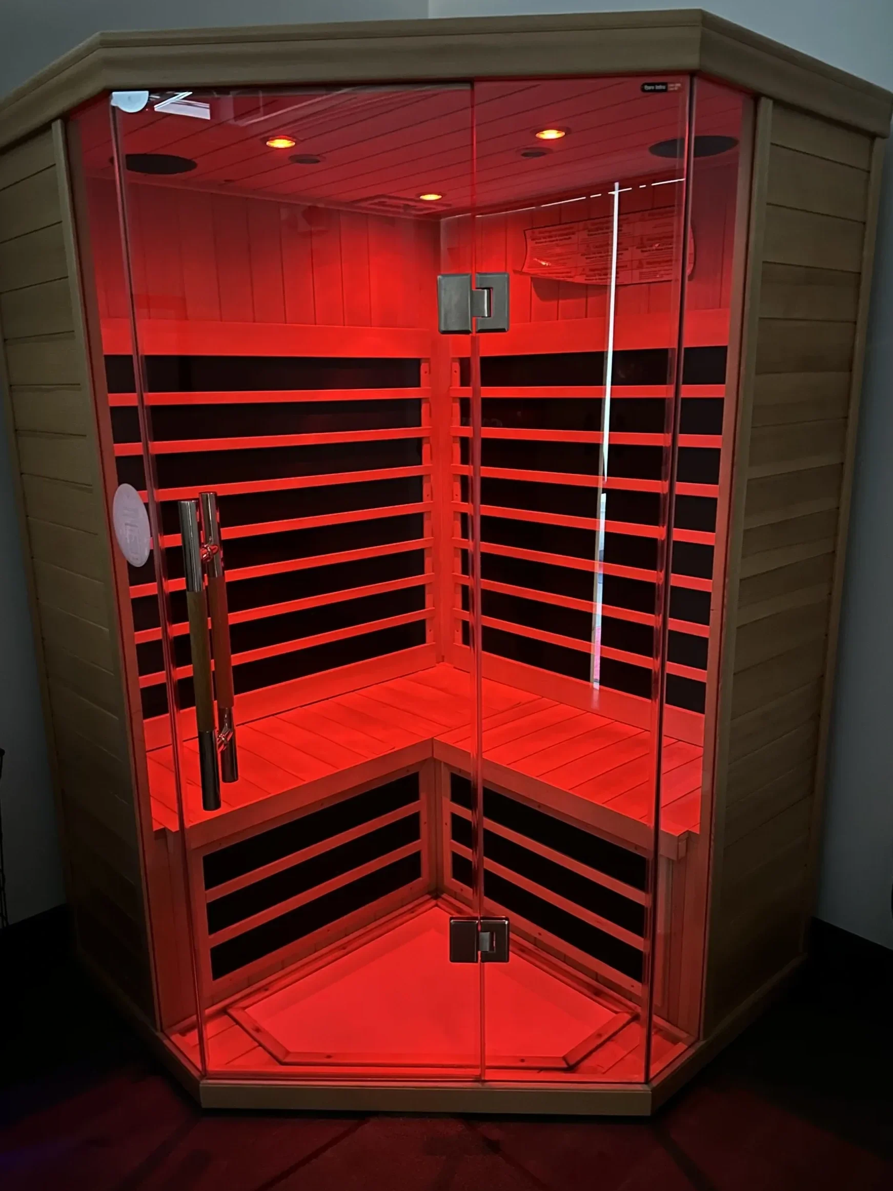 Private infrared sauna with red therapeutic lighting for relaxation and recovery