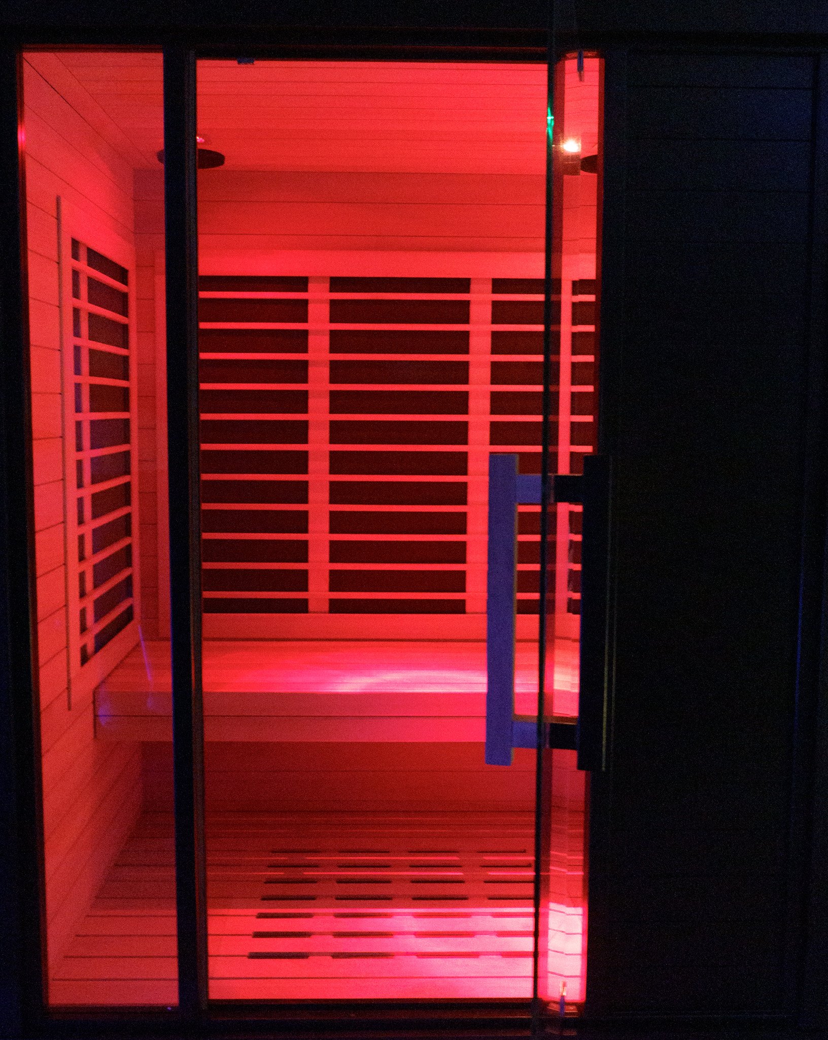 Red-lit infrared sauna cabin
