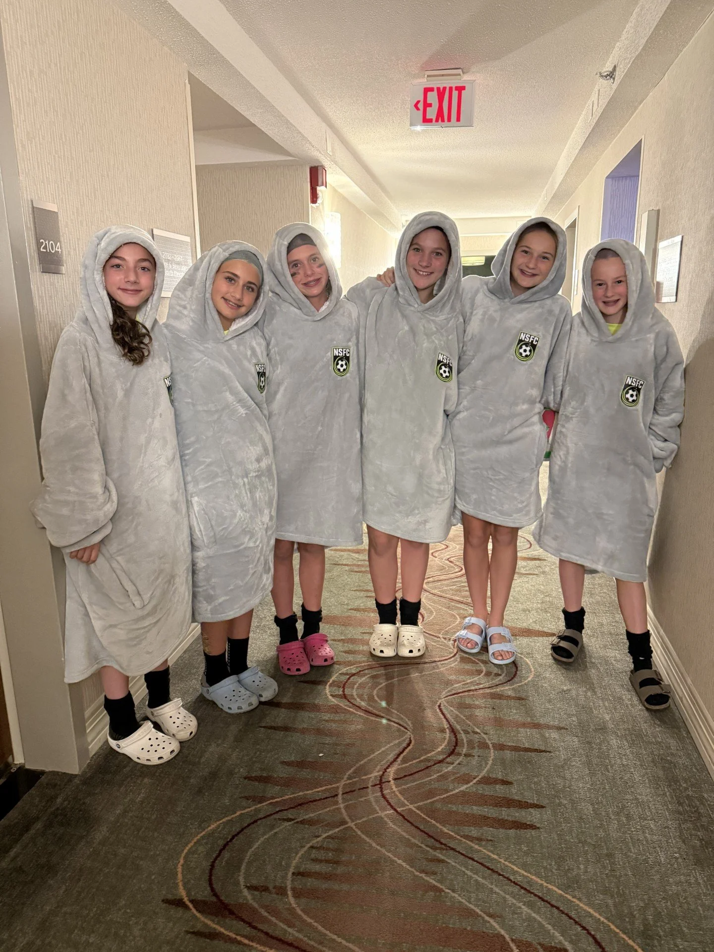 North Shore FC teammates together in pajamas and hoods