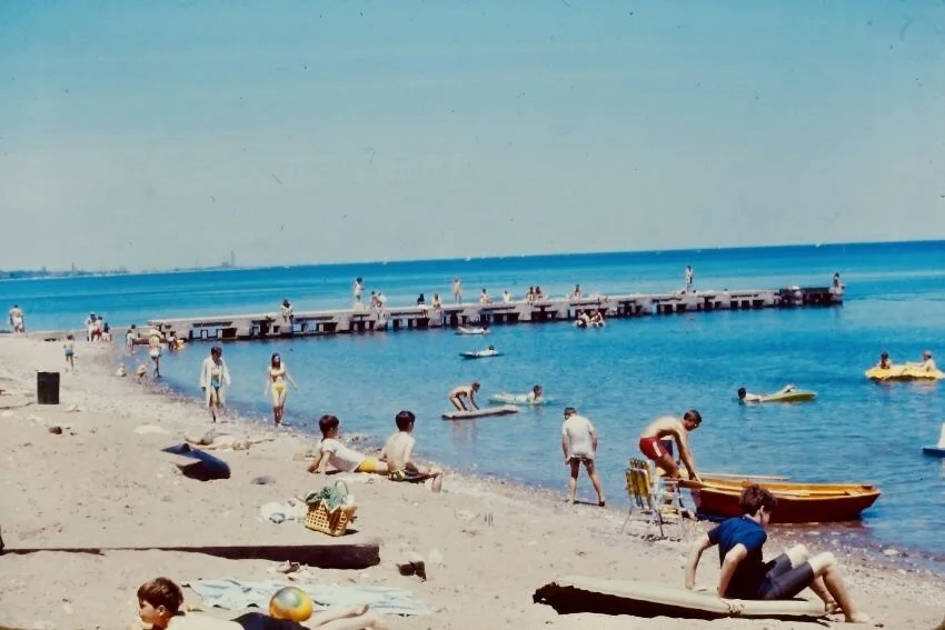 Lake Bluff Beach in summer 1969, with families swimming and relaxing along Lake Michigan.