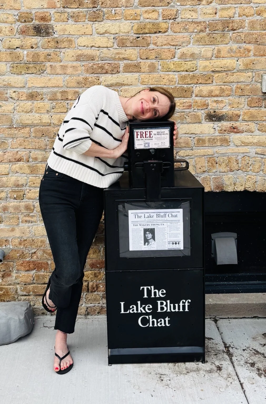 Megan Paszczykowski beside a Lake Bluff Chat newspaper box