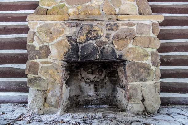 A stone fireplace with smoke staining due to venting issues.