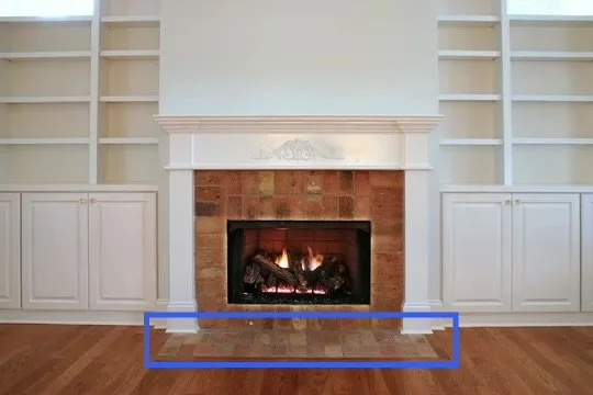 A fireplace with hearth extension that is flush with the floor.