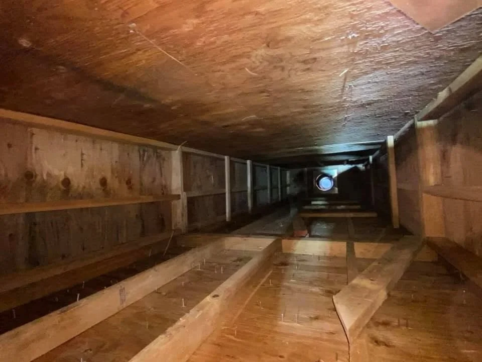 After the rotted prefabricated fireplace was removed. Interior of the chimney lacking insulation and firestops. This was not up to code. 