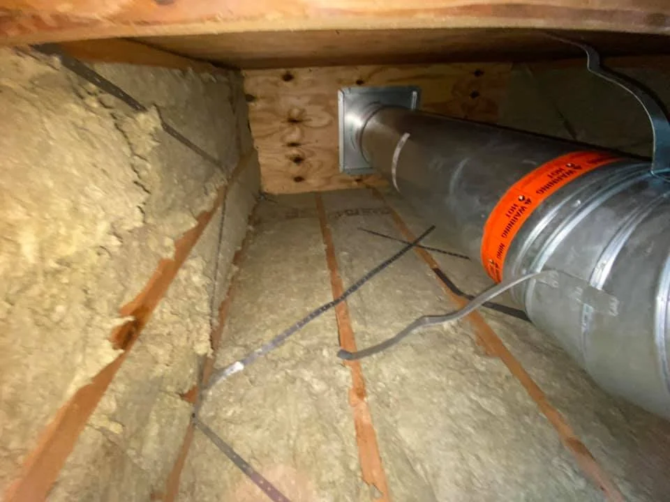 Inside the chimney chase of the new prefabricated fireplace. Insulation and firestop was installed to bring chimney up to code and pass inspection.