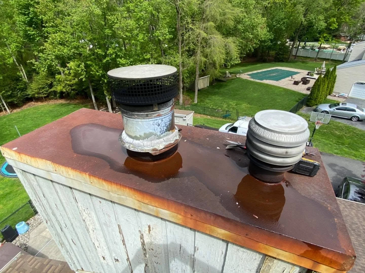 Most common repair, chimney chase cover, sometimes confused with a chimney cap, completely rusted and water pooling on top. Once the metal fails, water starts entering the chimney causing further damage. 