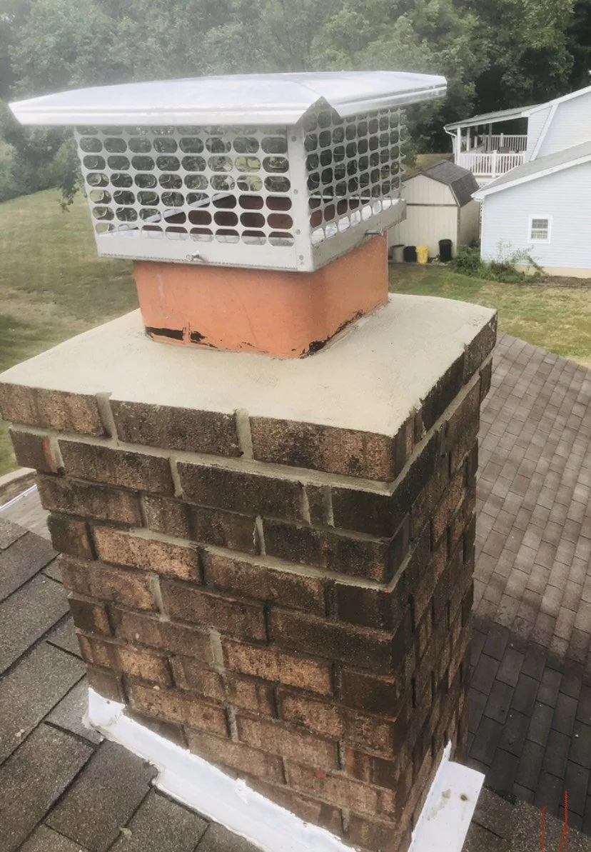Chimney partially rebuilt with new masonry wash. 
