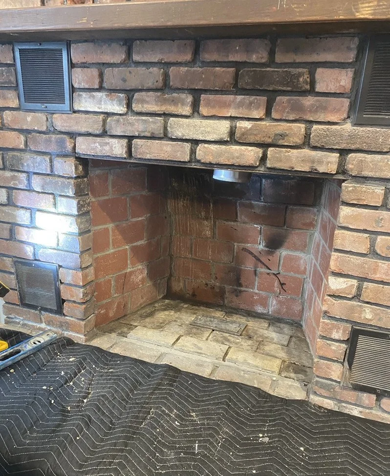 Unifficent fireplace being prepped for a wood stove.