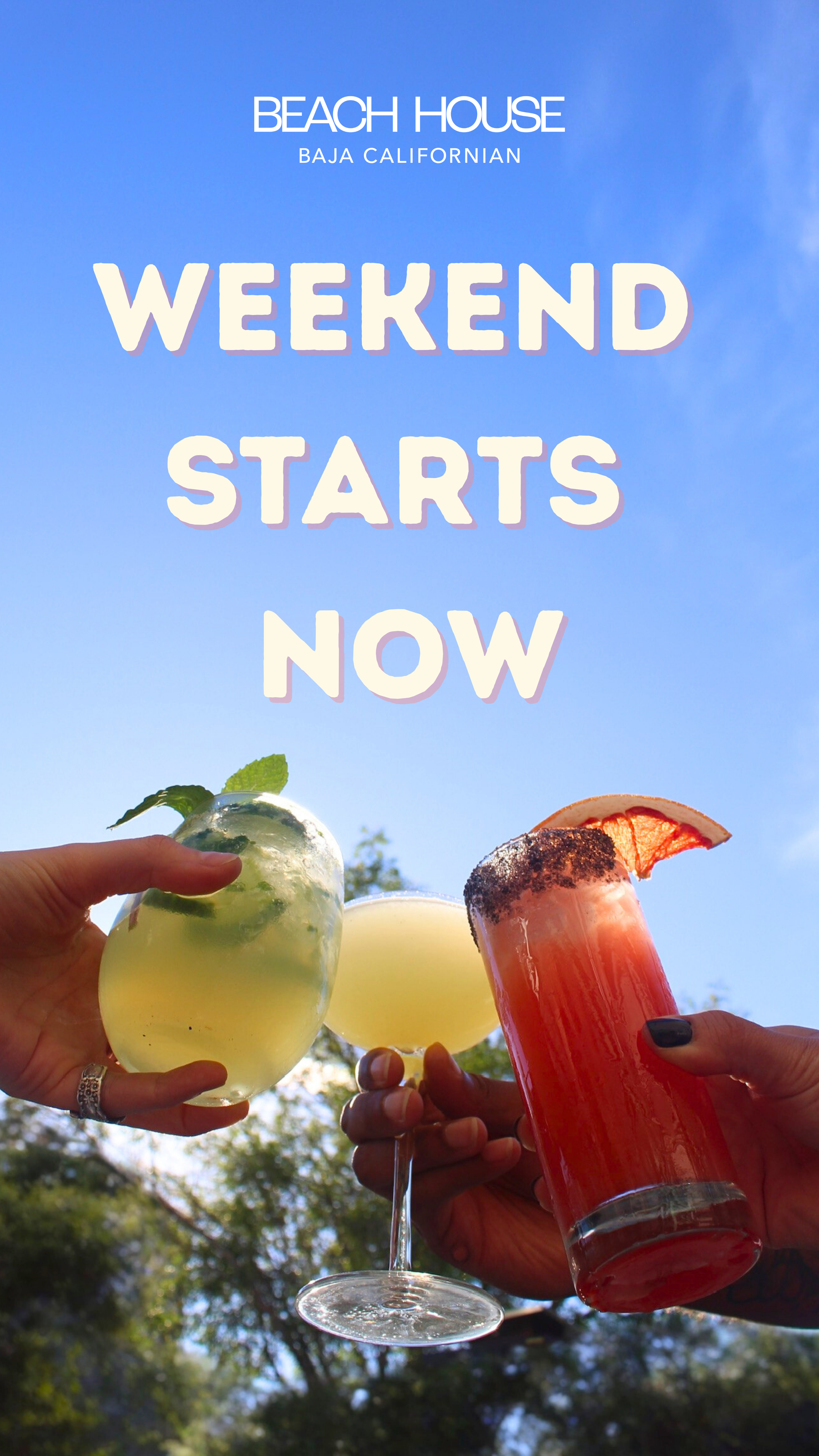 Several hands holding colorful cocktails with garnish, against a blue sky and trees, with text about a weekend start at the beach house in Baja California.