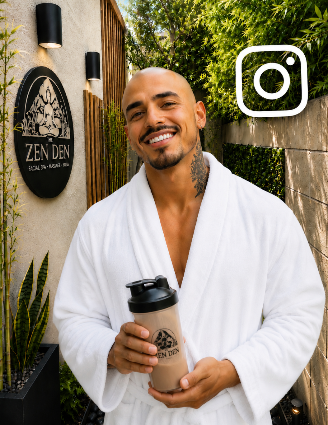 A smiling man in a white bathrobe holding a protein shake in a to-go cup with a Zen Den logo, standing outdoors near green foliage and a sign for The Zen Den facial spa, massage, and yoga.