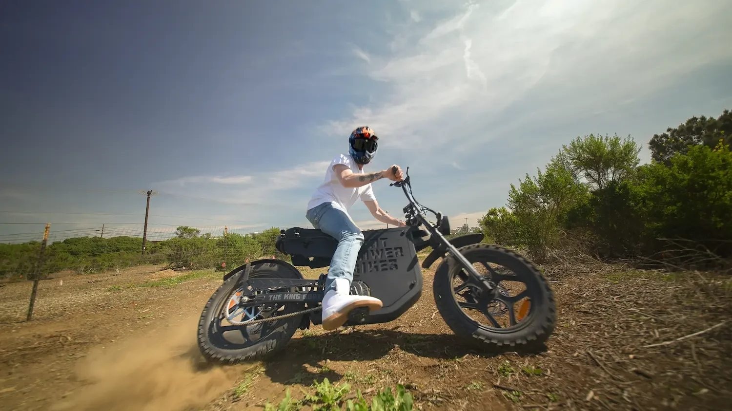 Rider drifting dramatically throwing dust on a fat-tire electric bike on a dirt trail