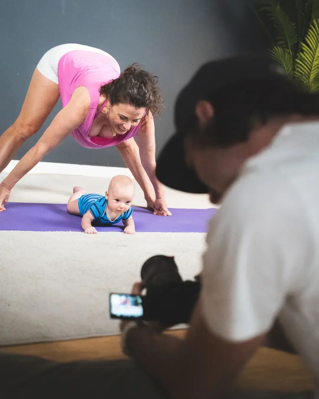 Photographer capturing a mother and baby during a yoga-inspired photo session