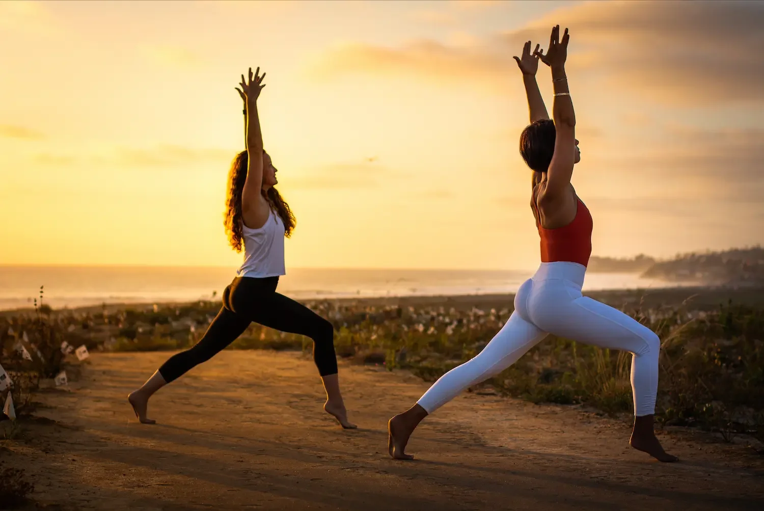 two female yoga teachers are photographed performing asana before the sunset in San Diego