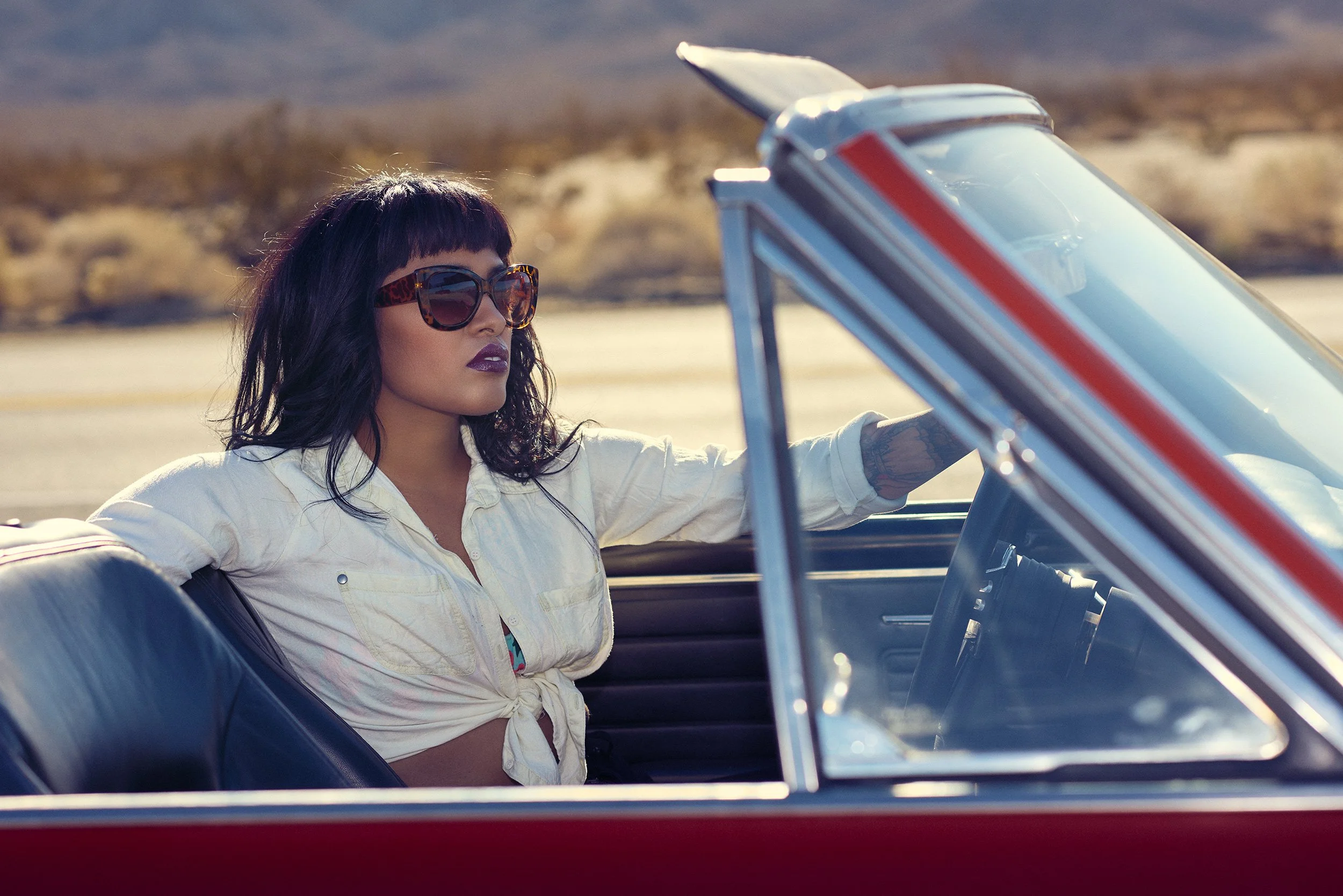 Lisa Jennigs photographed in a vintage red convertible for the WESTBOUND fashion editorial in Anza-Borrego, San Diego County.