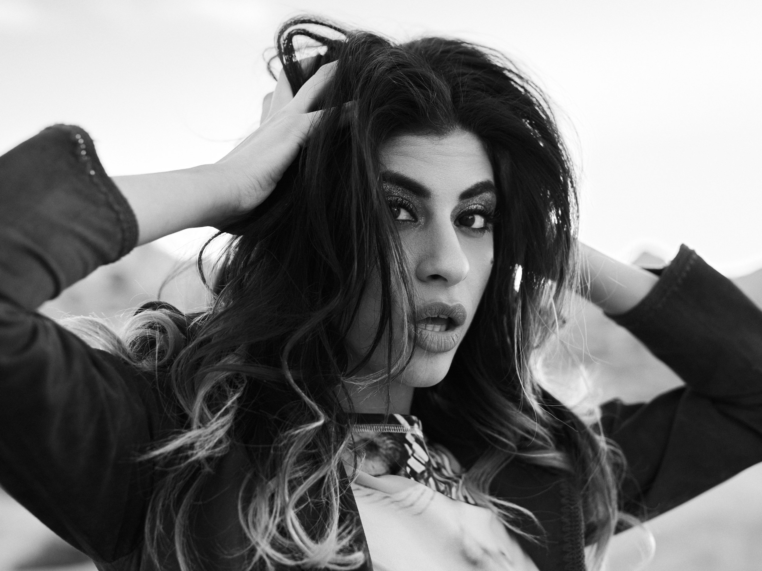 Black-and-white close fashion portrait of Vart photographed during the Desert Gold editorial.