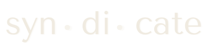 Close-up of the word 'syn·di·cate' written in white text on a black background.