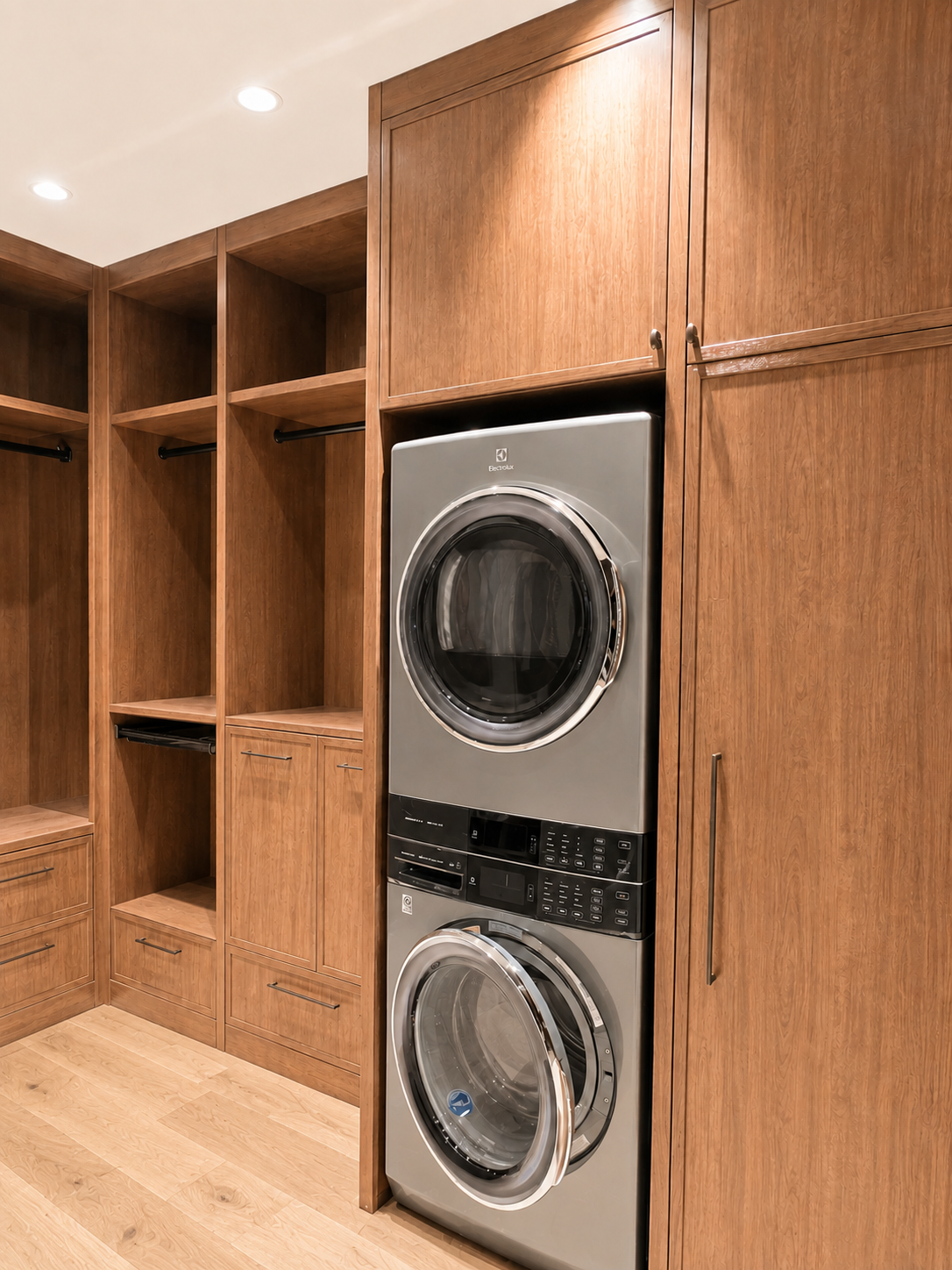 Stacked front-loading washer and dryer in a wooden closet with open shelves and drawers.