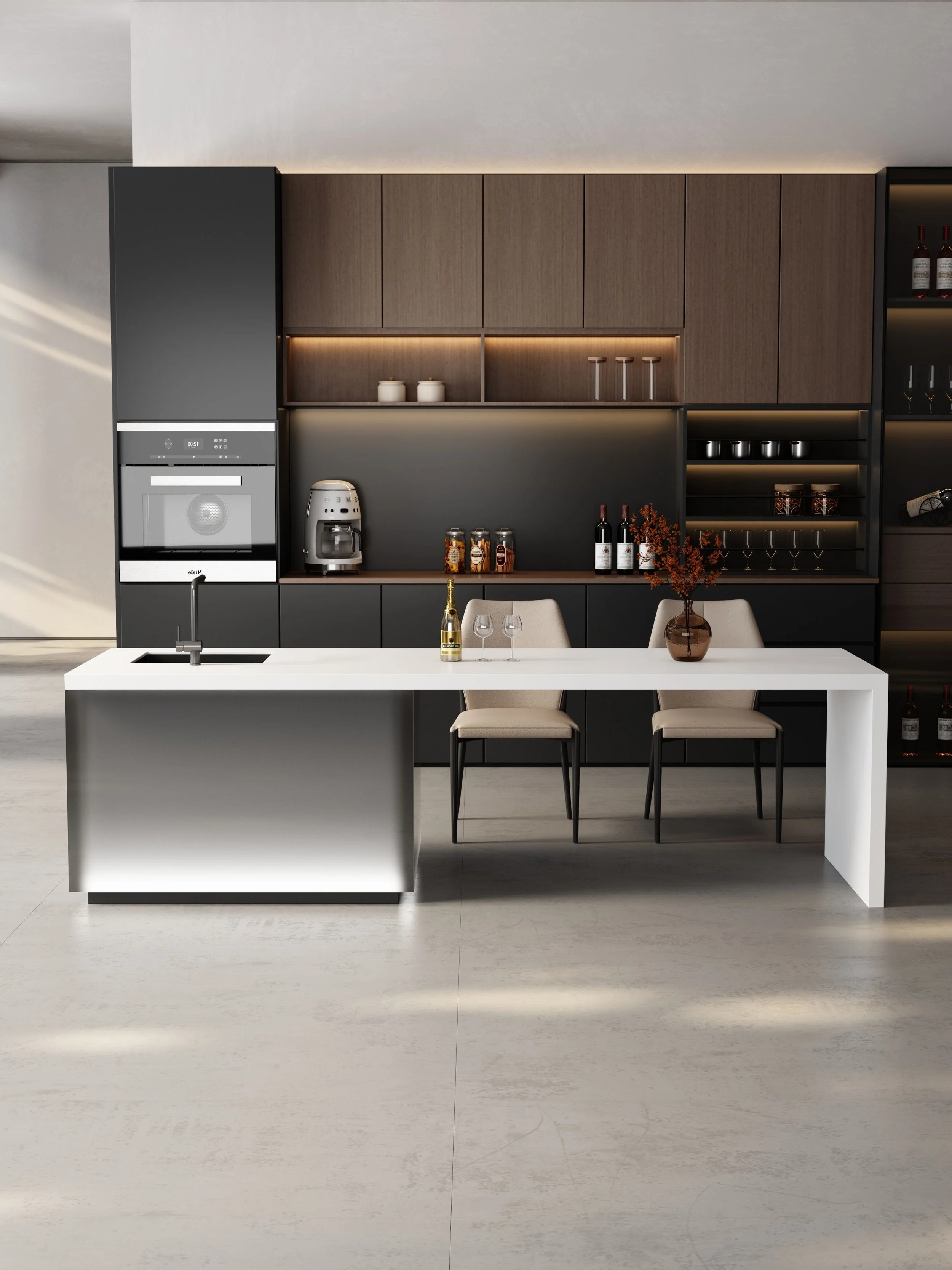Modern kitchen with white island, two chairs, dark cabinets, upper and lower cabinets, wine bottles, glasses, decorative jars, and a coffee machine.