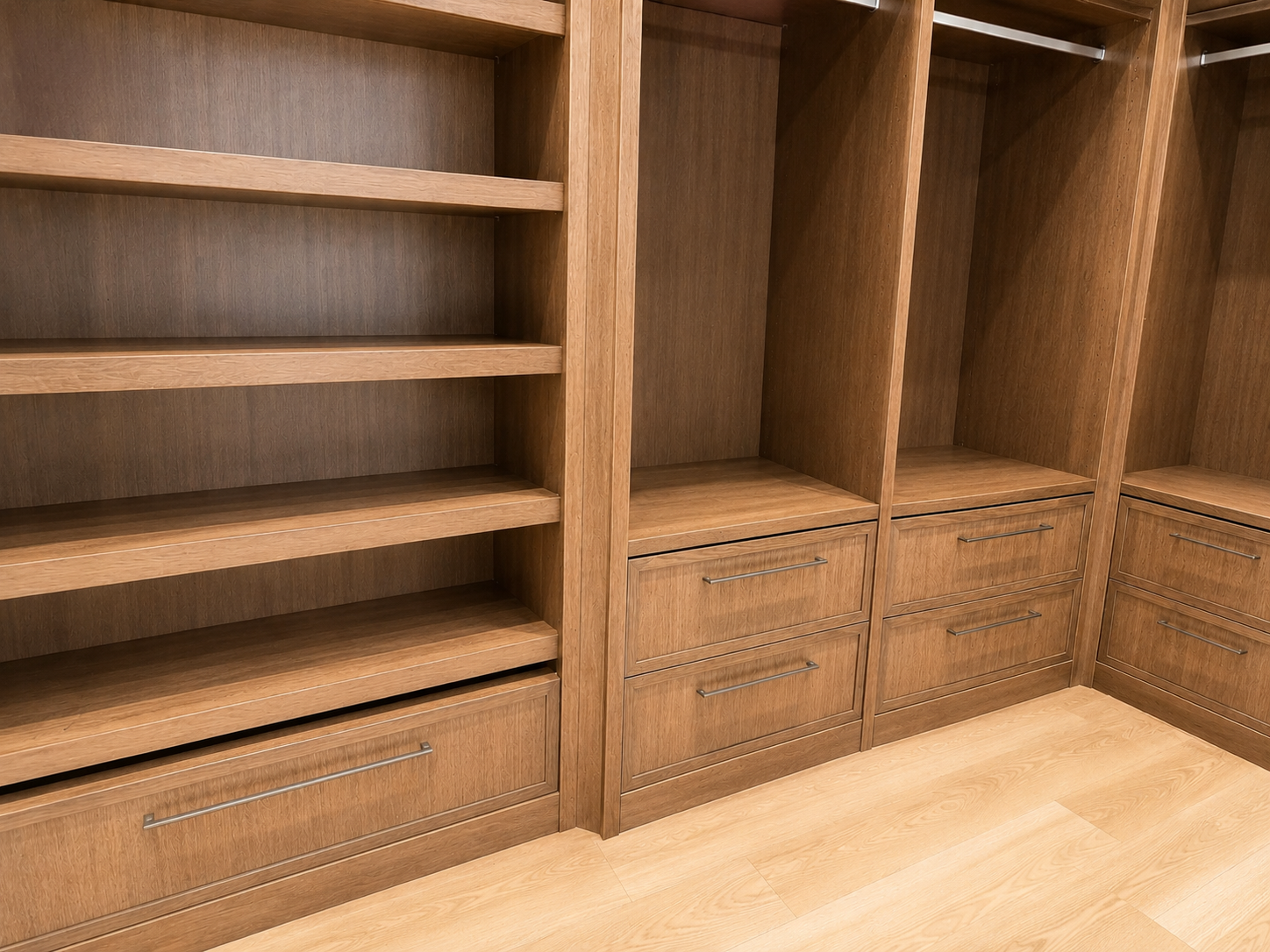 Empty wooden closet with shelves and drawers.