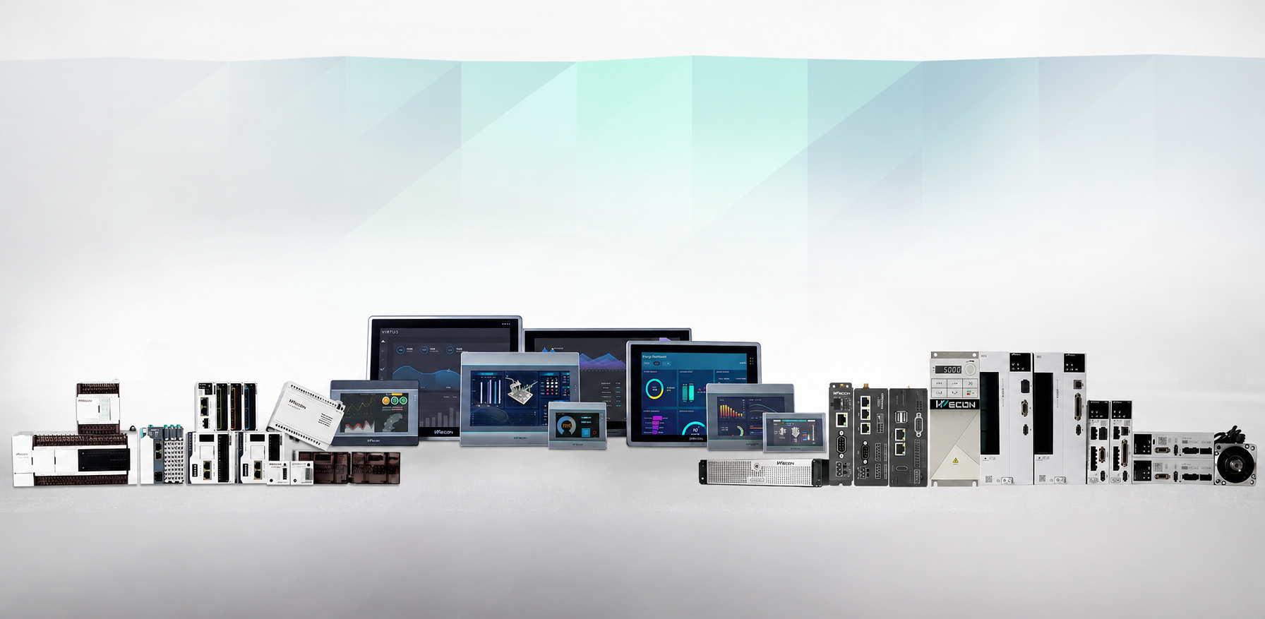 Various industrial electronic devices and control panels, some with display screens, arranged on a white surface against a minimalist background.
