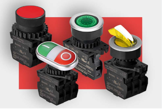 Four industrial push buttons and switches with different colors and functions on a red background.