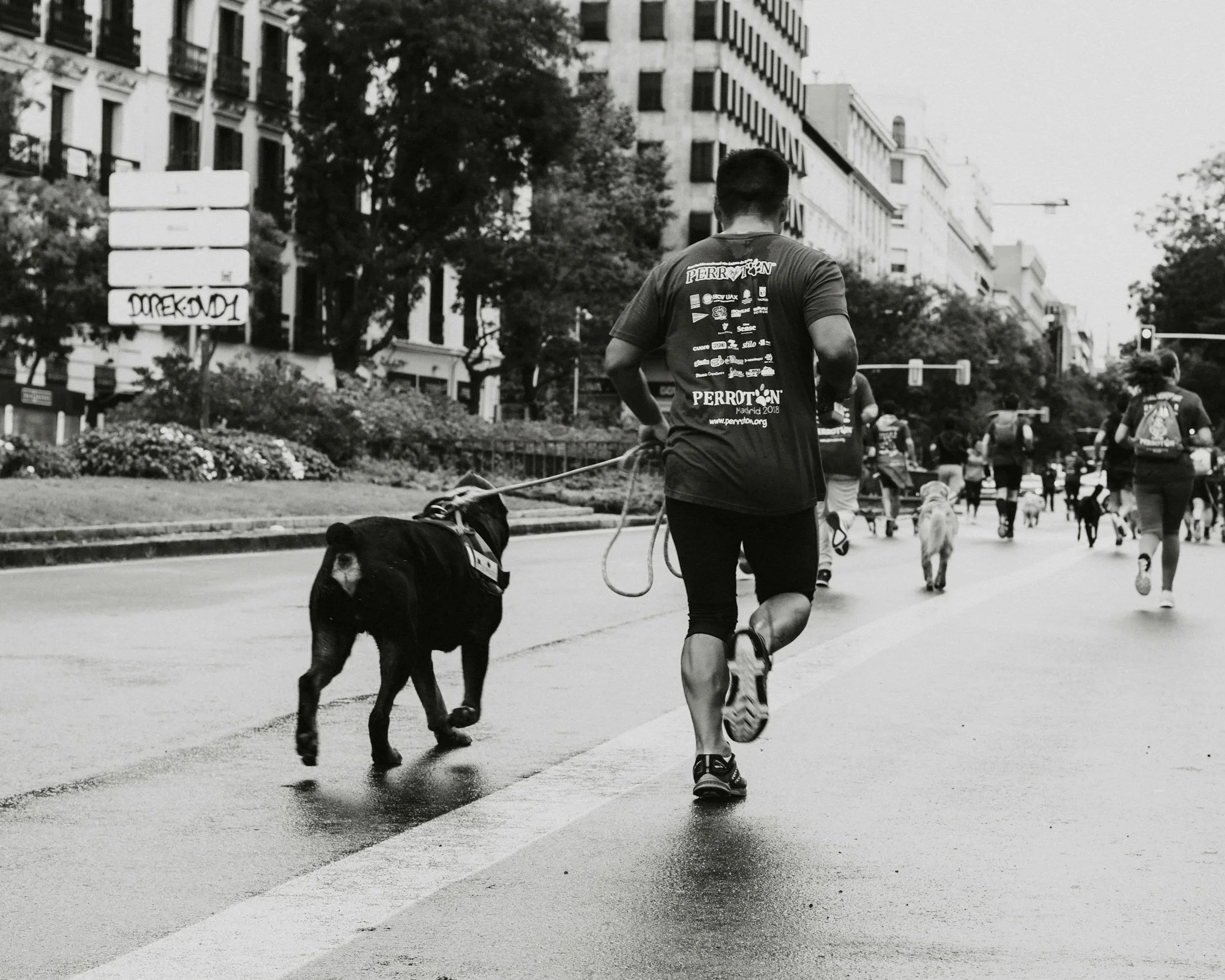 A man running with his dog