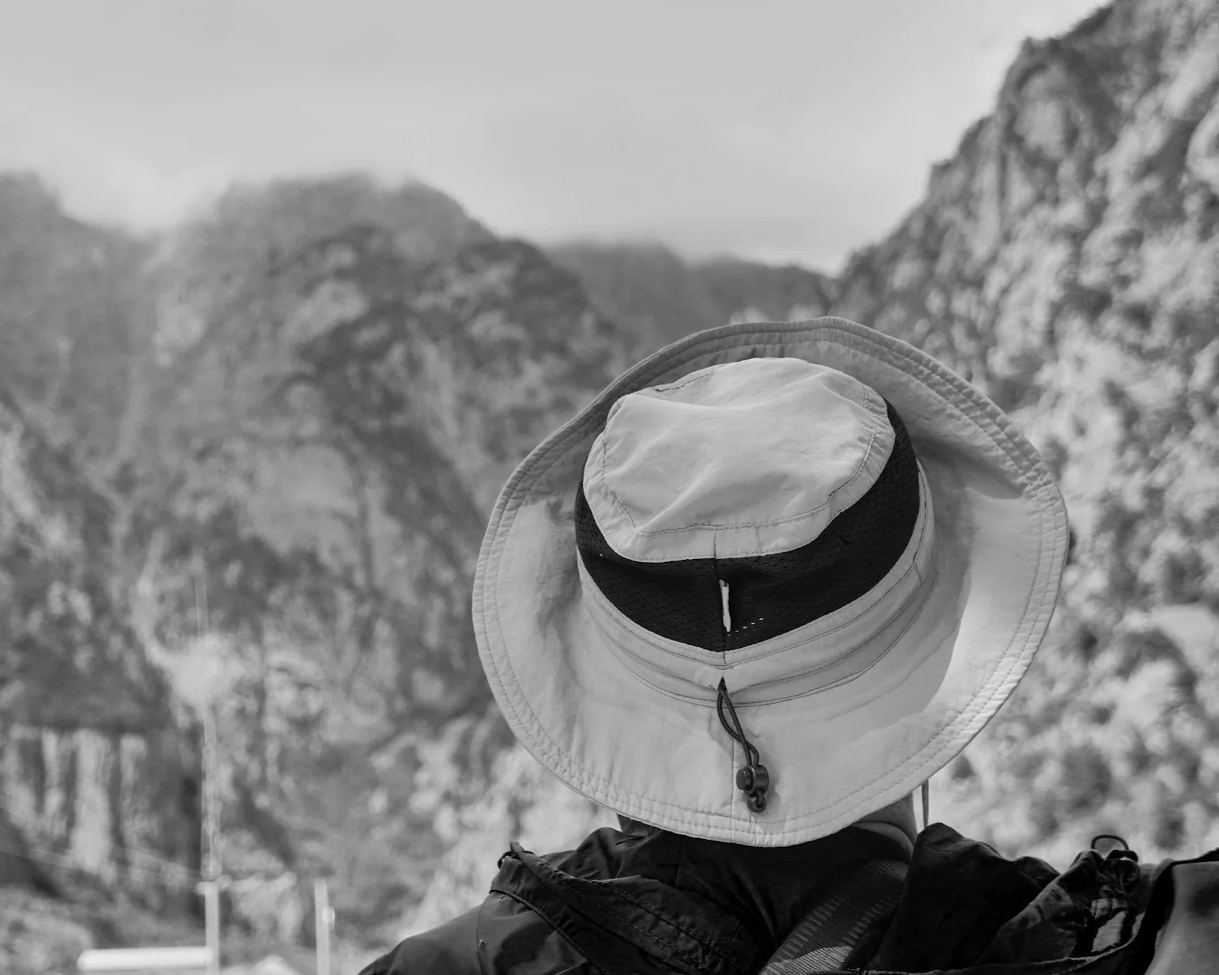 Person in a hat, traveling in the mountains