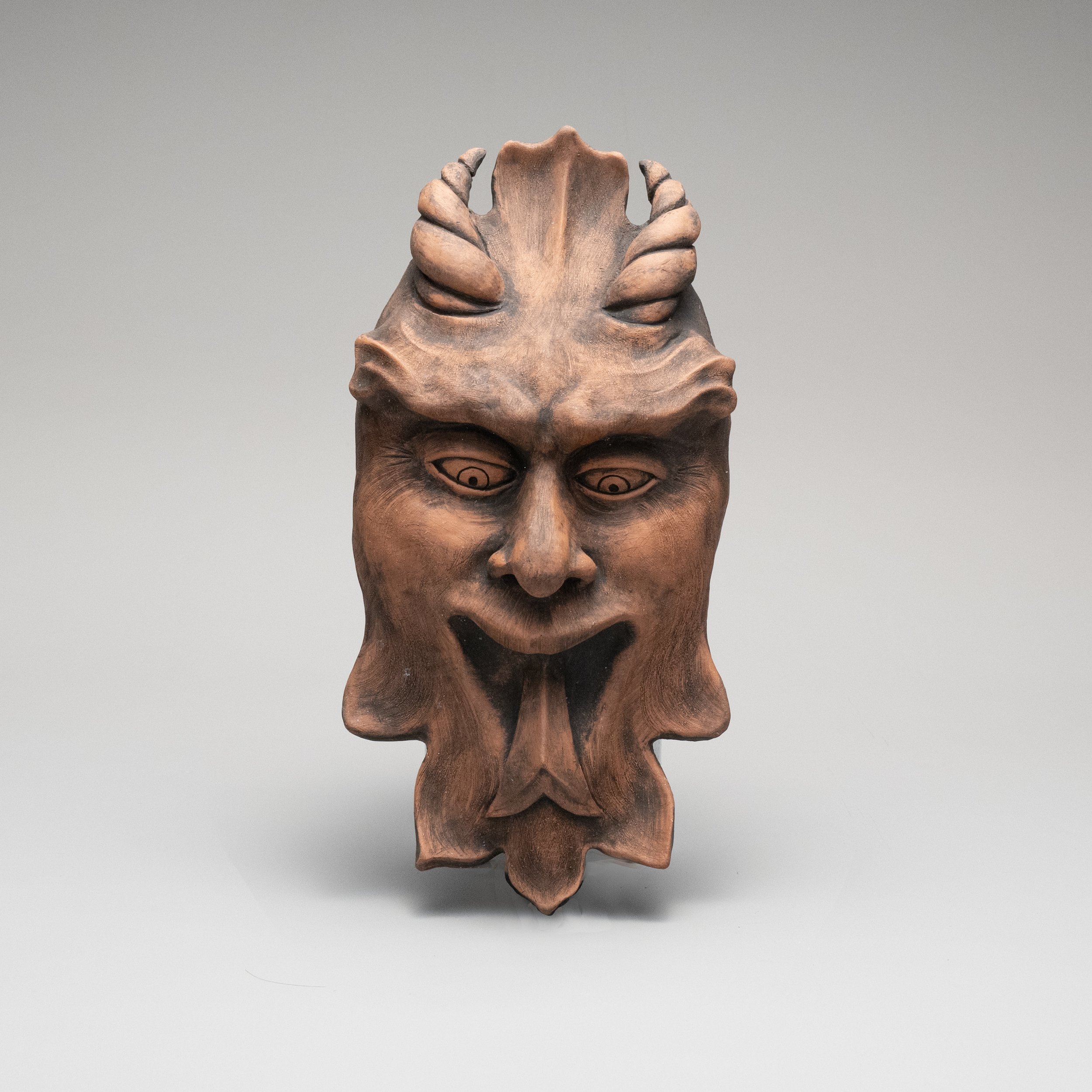 Whimsical Garden Art: Forked Tongue Devil Face