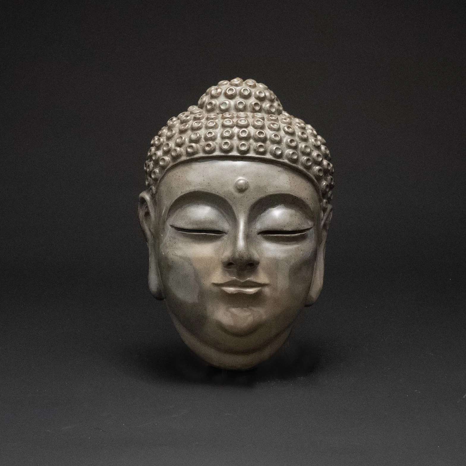 Serene Garden Art: Celadon Buddha Face
