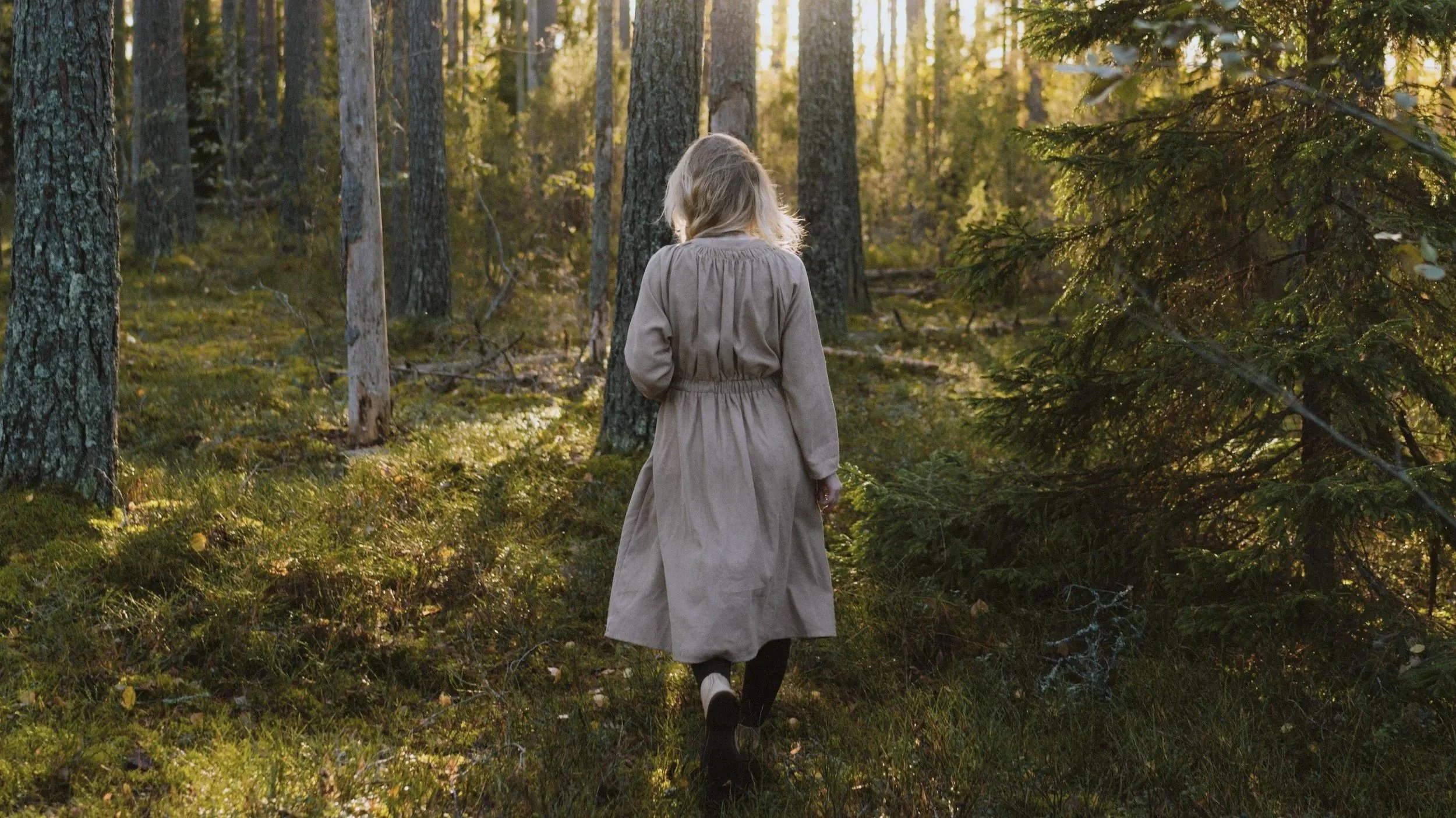 A young woman walking alone along a peaceful forest path, symbolizing self-discovery, healthy boundaries, and growing confidence in her own voice.
