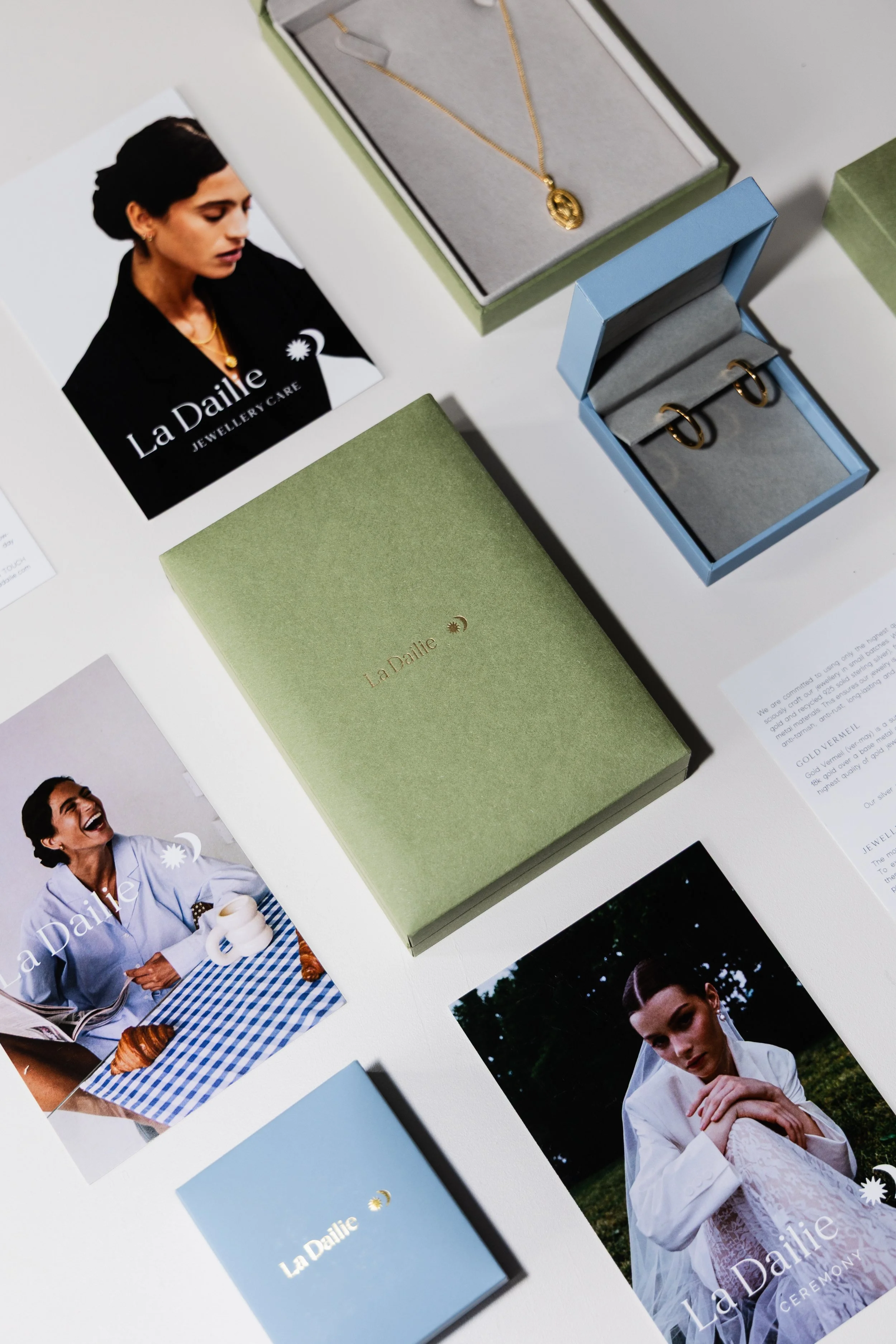 Flat lay brand photography for La Dailie featuring jewellery packaging, branded stationery and lifestyle imagery in a cohesive editorial composition.