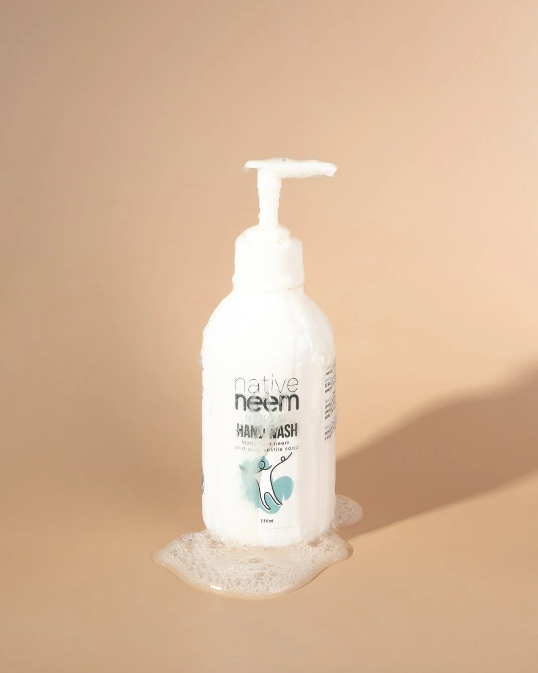 Product photography of Native Neem hand wash, showcasing natural skincare packaging on a warm neutral background.