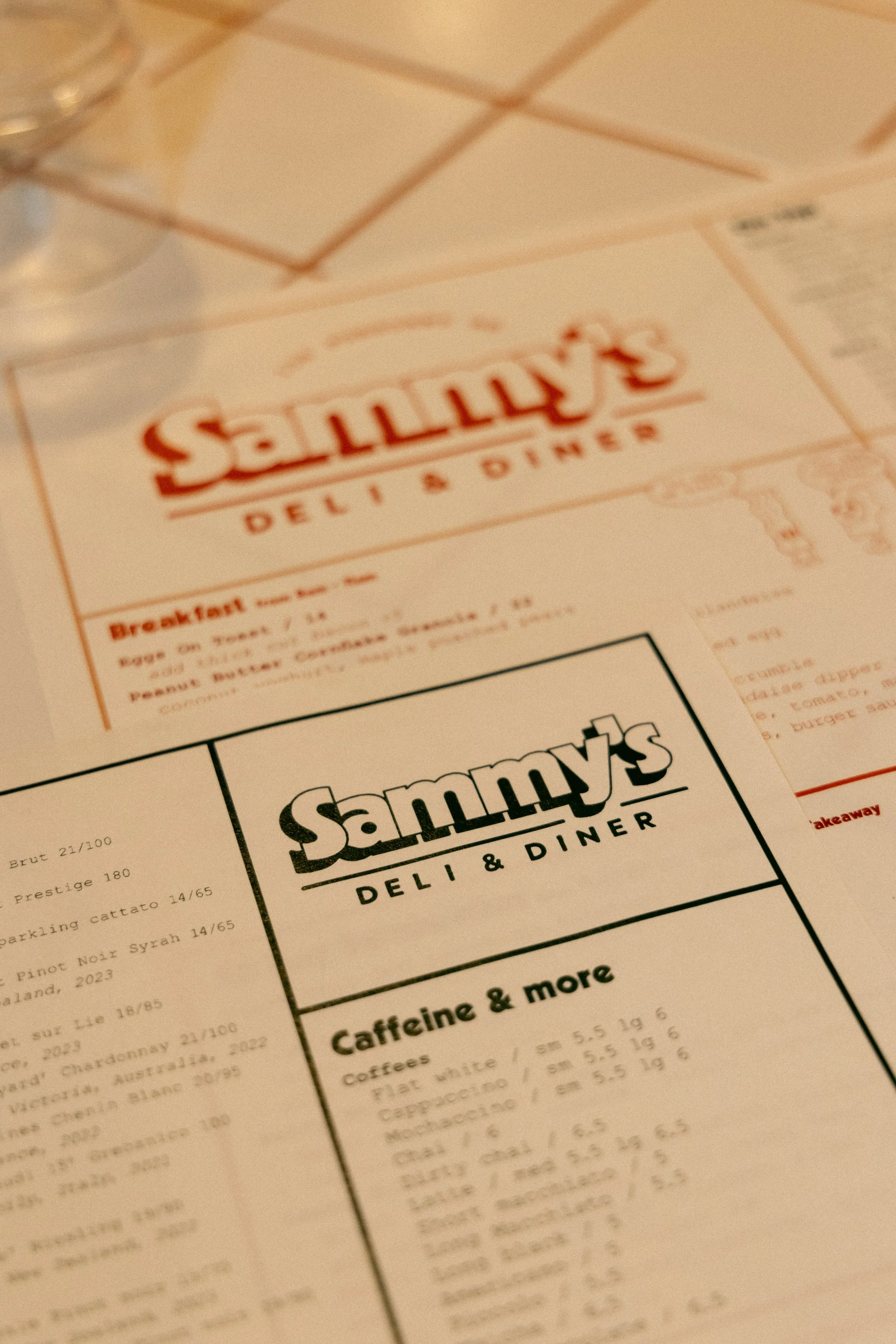 Close-up of the Sammy's Deli & Diner brand identity, showcasing custom menu design and restaurant branding created by Aura Studio.