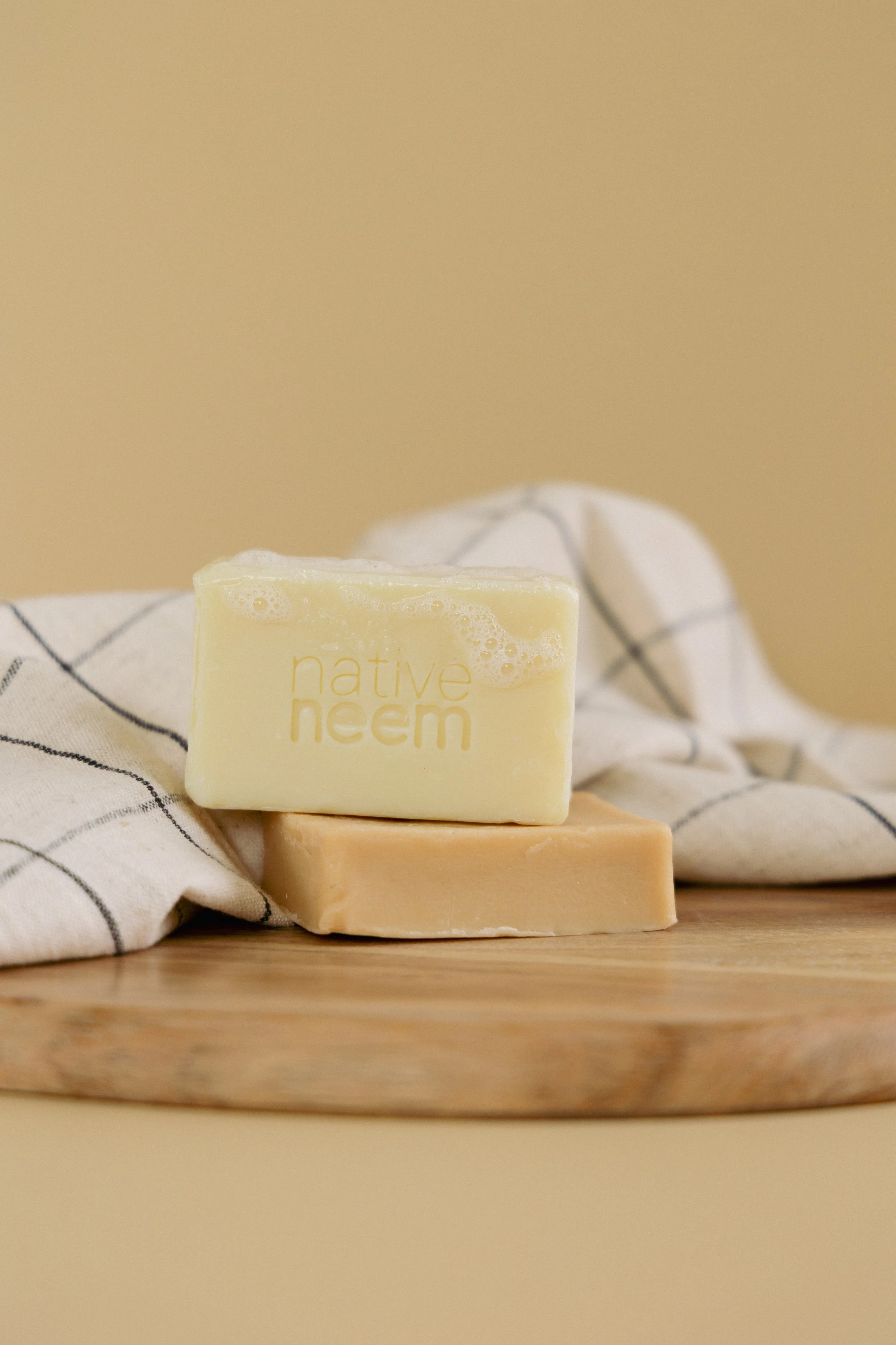 Product photography of Native Neem natural soap styled for branding and e-commerce.