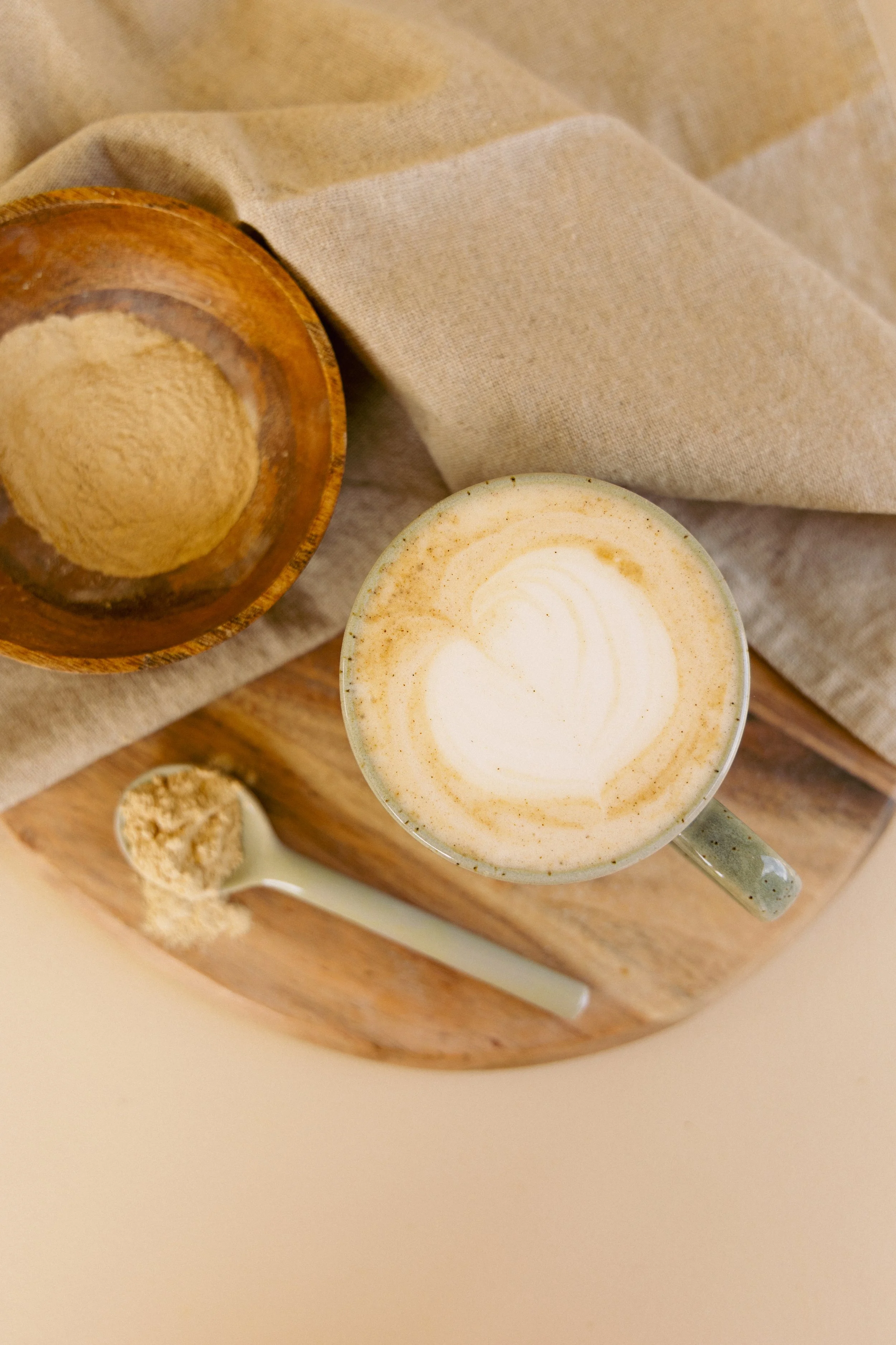 Lifestyle product photography featuring a Green Trading turmeric latte with turmeric powder for social media content creation.