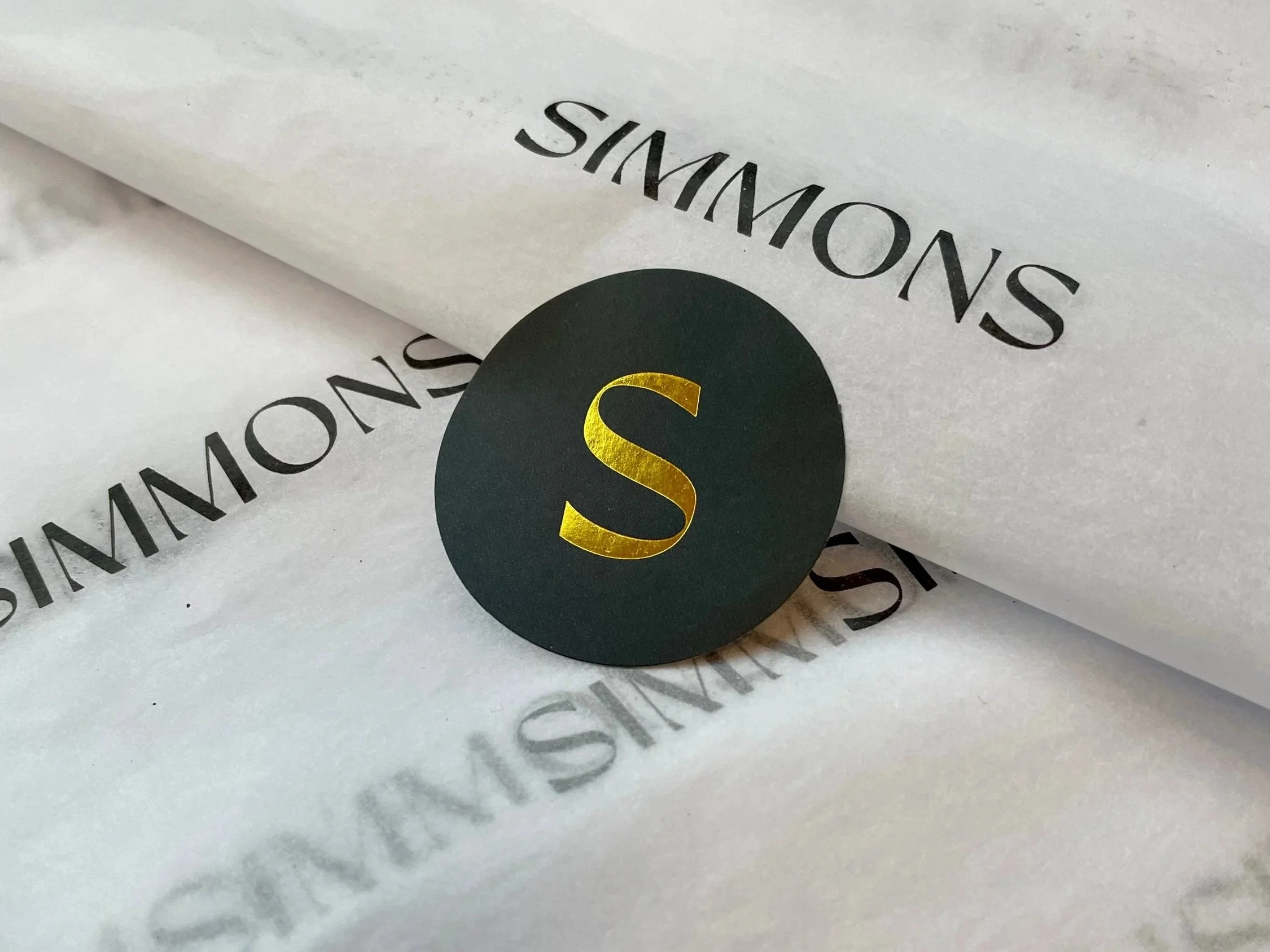 Simmons branding materials featuring the brand logo and premium packaging design created by Aura Studio.