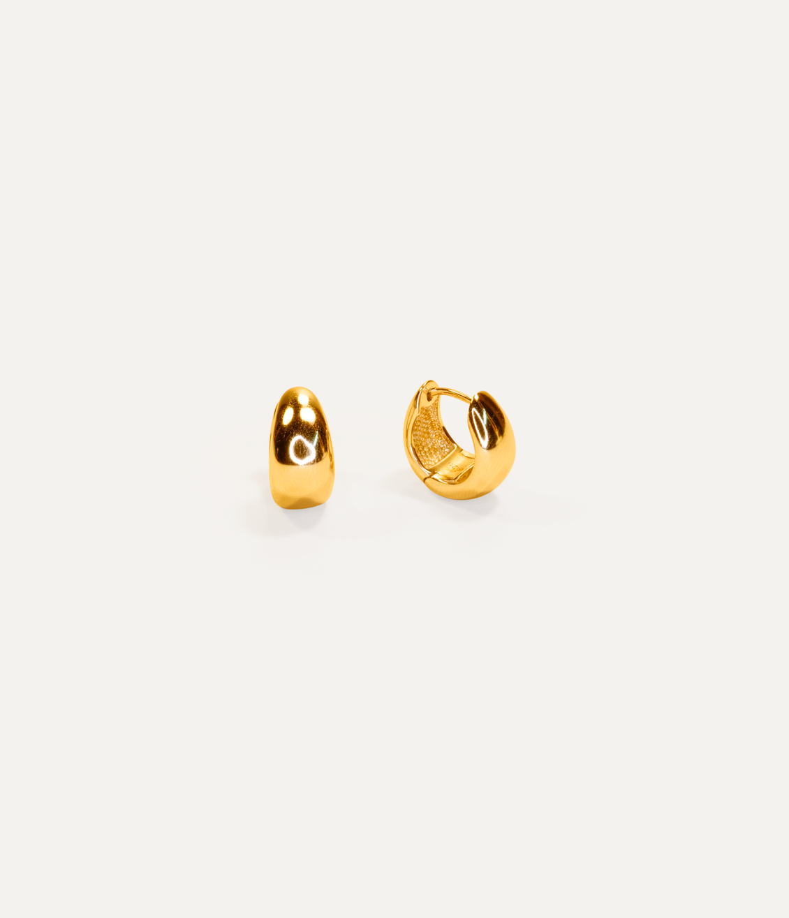 Studio product photography of La Dailie gold hoop earrings, showcasing a minimalist jewellery design on a clean neutral background.