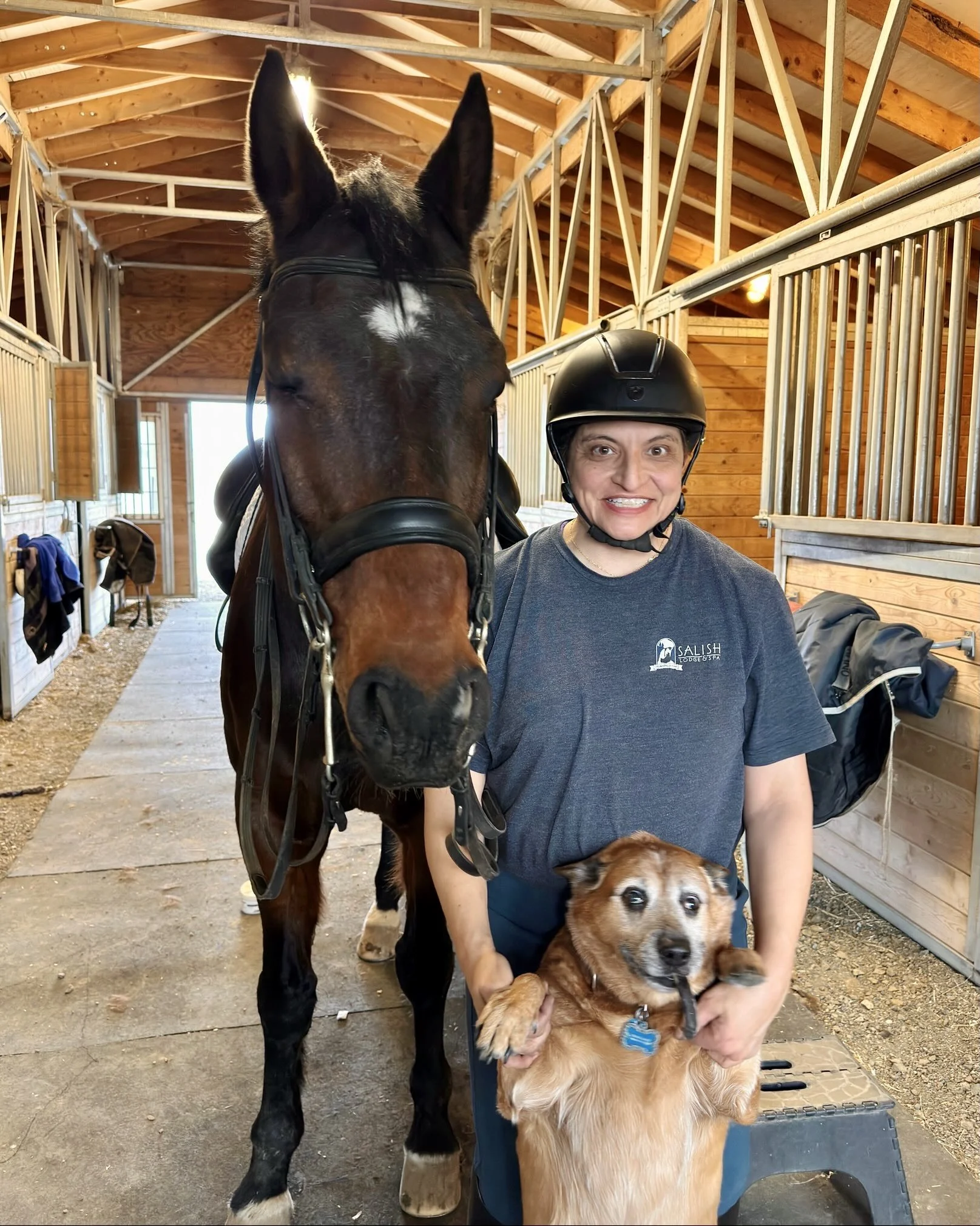 Janelle Carman-Wagner (JCW) standing in front of her horse with her dog int he foreground.