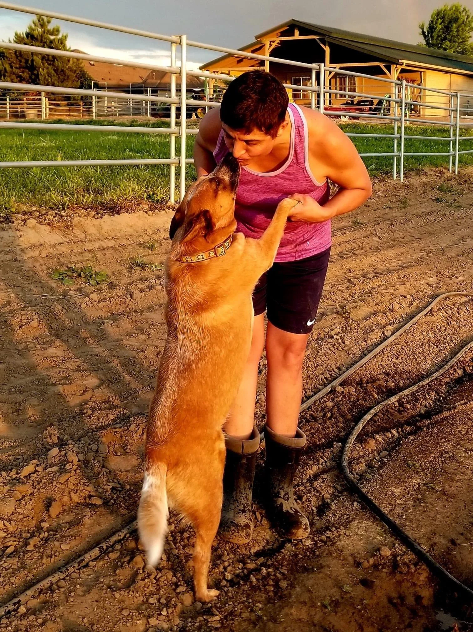 Janelle Carman-Wagner (JCW) holding her dog's front paws.