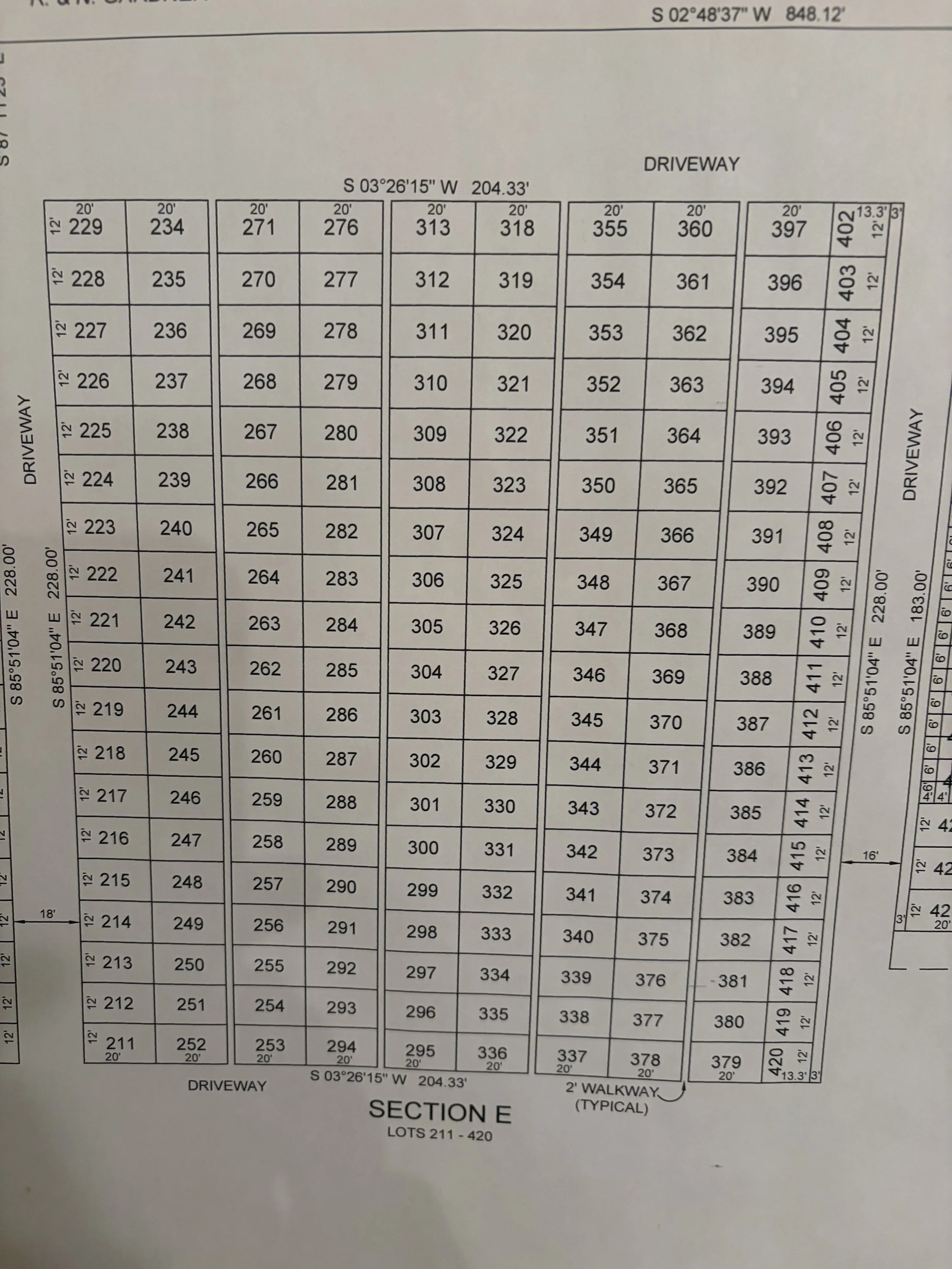 A detailed plot map of land lots and streets, showing lot numbers, dimensions, and section information.