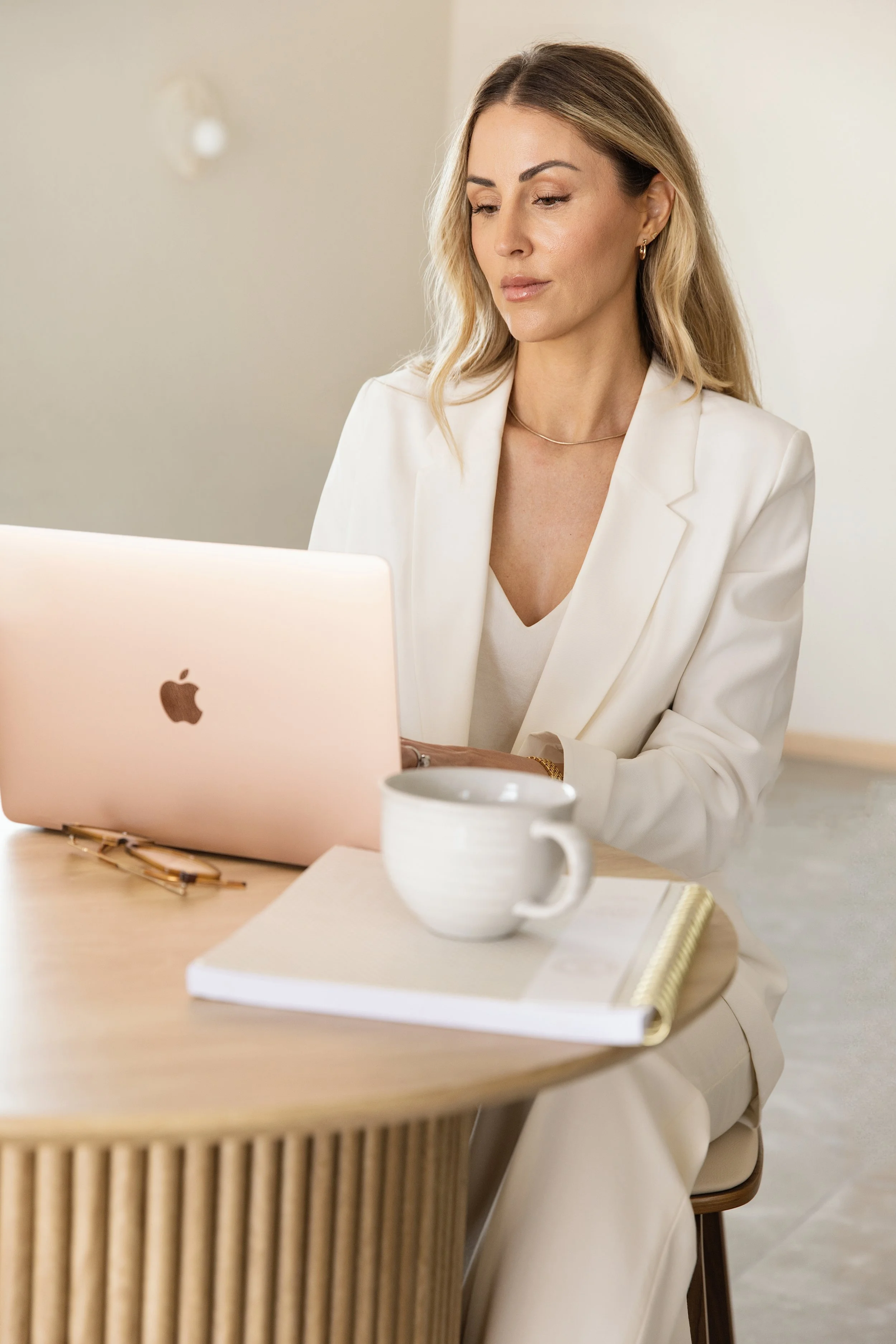 Anna Batke, FNC-P working on her laptop with a warm beverage