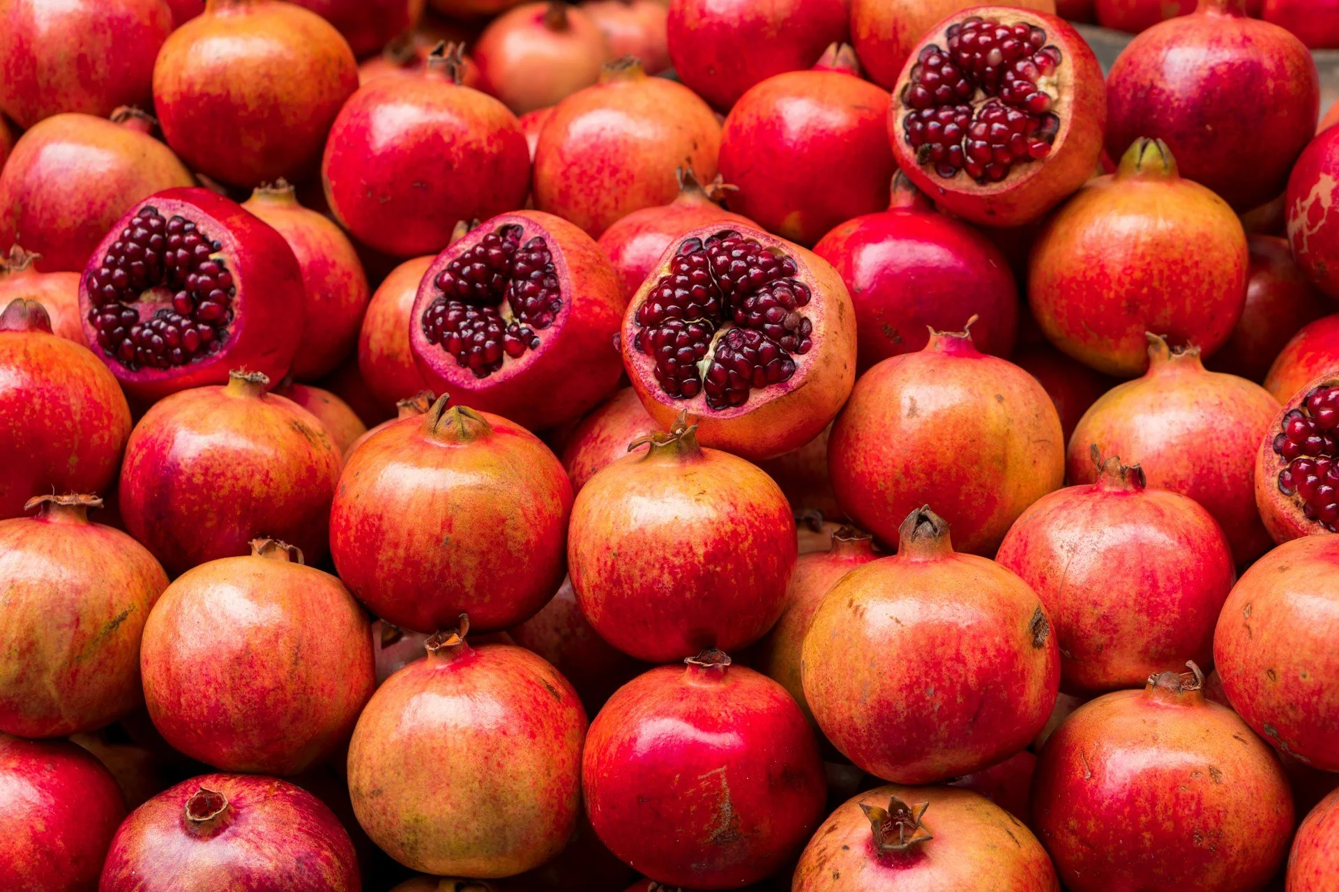 Fresh pomegranates representing the botanical heritage, sensory traditions, and landscapes that inspire Scents of Sicily.