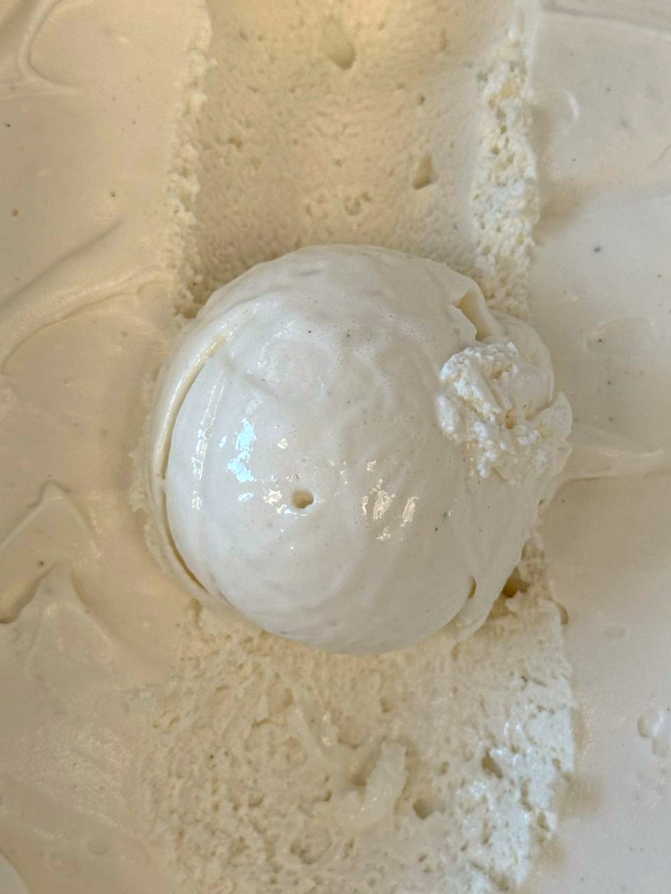 Close up of a white scoop of Vanilla ice cream