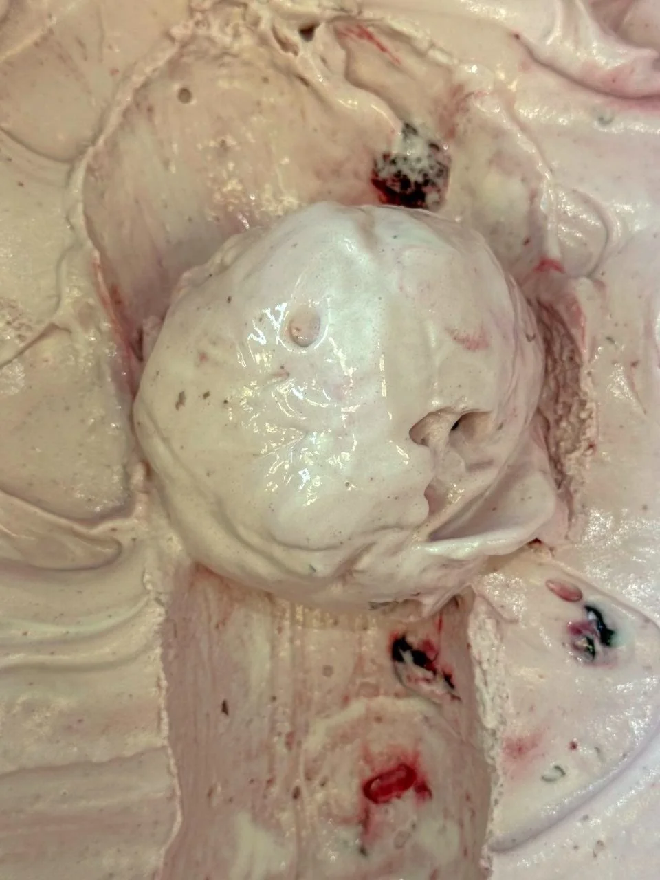 Close up of a pink scoop of Sour Cherry ice cream