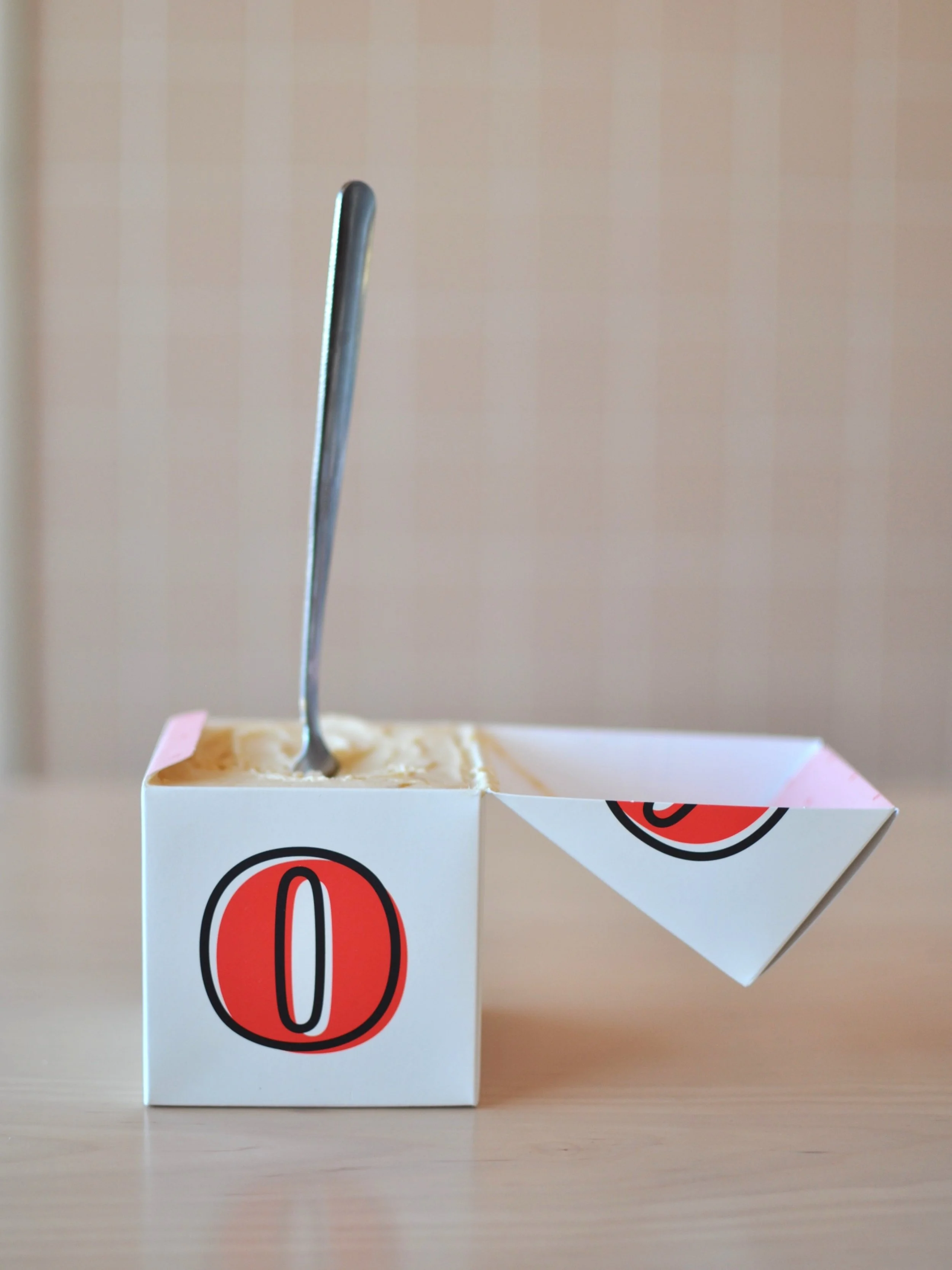Cute vintage cube pint with X and O on each side and a spoon in it