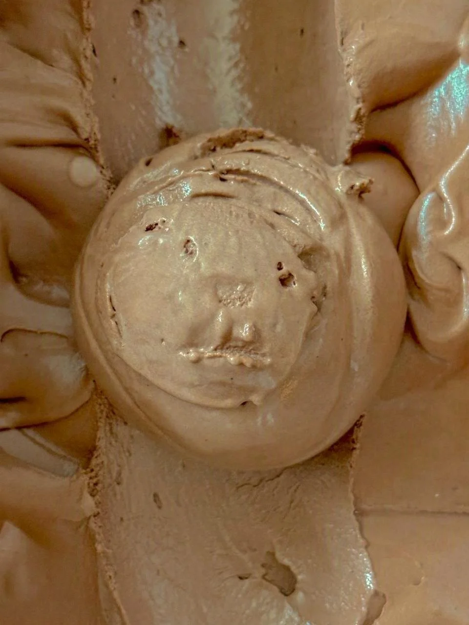 Close up of a brown scoop of Chocolate ice cream