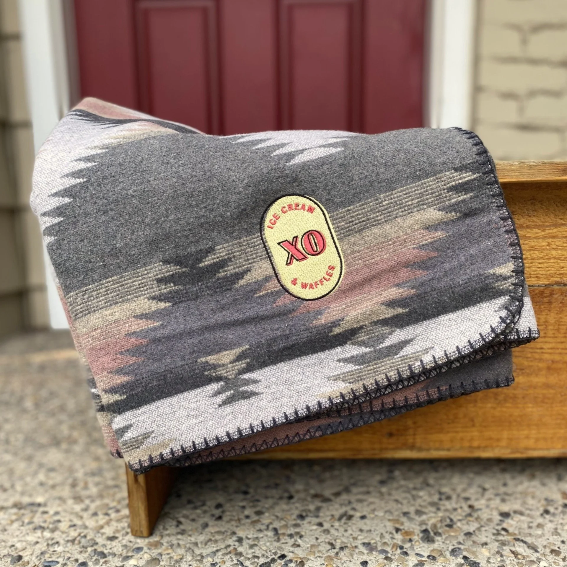 Cozy blanket with Canadian pattern and XO logo patch